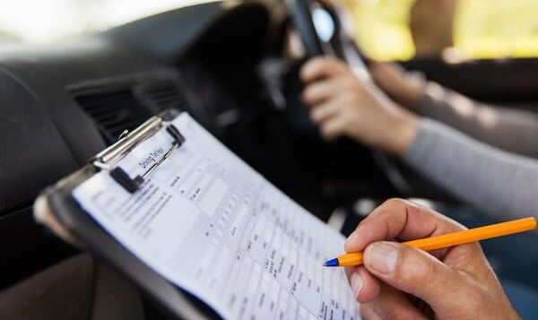 Driving instructor helping a student learn to drive in Godalming